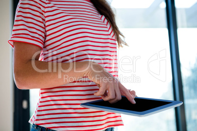 woman pointing at the screen of her tablet