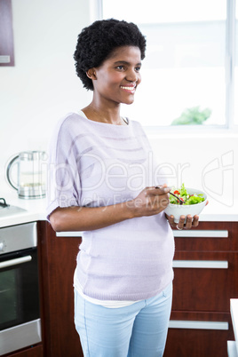 Pregnant woman eating salad