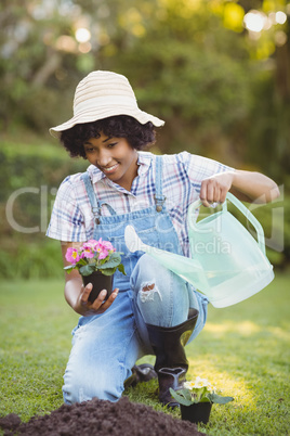 Smiling woman crouching in the garden