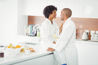 Happy couple hugging in the kitchen