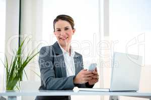 smiling business woman on her mobile phone