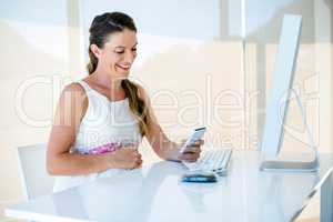 smiling pregnant woman on her mobile phone