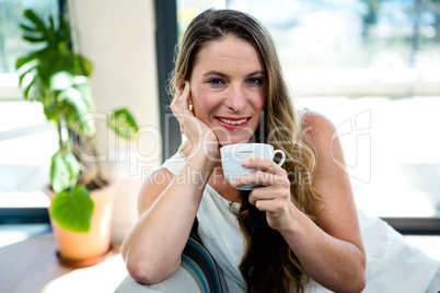 beautiful woman sipping coffee and smiling
