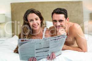 Smiling couple lying in bed