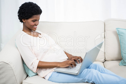 Pregnant woman using laptop