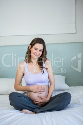 Pregnant woman touching her belly