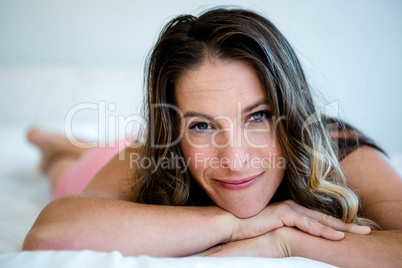 smiling woman on her bed