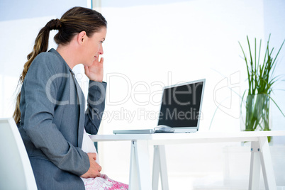 pregnant business woman sittting at her desk