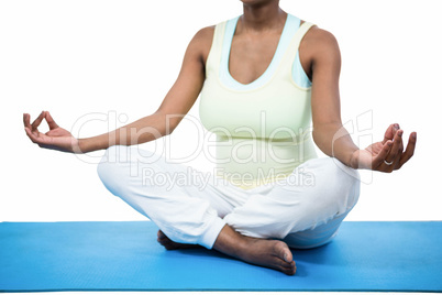 Pregnant woman meditating on mat