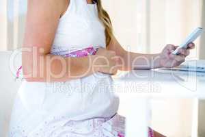 pregnant business woman on her mobile phone