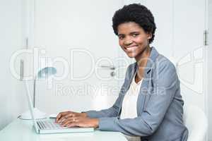 Pregnant businesswoman using laptop