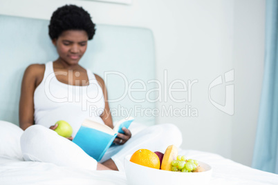 Pregnant woman reading a book