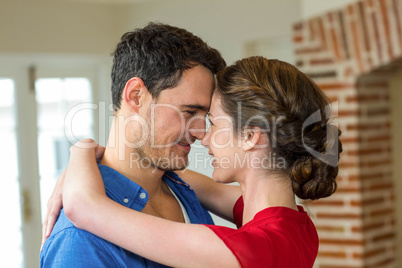 Romantic couple standing face to face and embracing each other