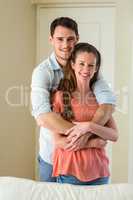 Young couple embracing in living room