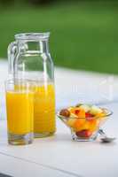 View of bowl of fruit salad and orange juice