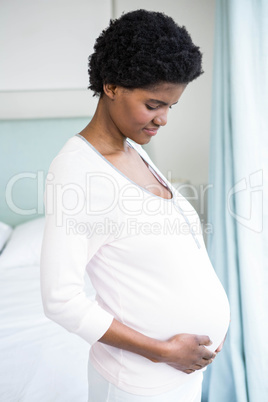 Pregnant woman touching her belly