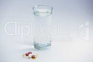 Pills beside glass of water