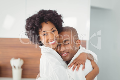 Happy couple hugging in the kitchen