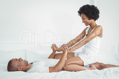 Happy couple playing on the bed