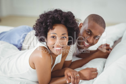 Smiling couple lying on the bed