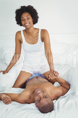 Happy couple playing on the bed