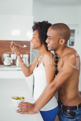 Happy couple eating fruit together