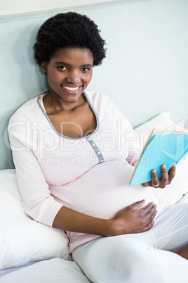 Pregnant woman reading a book