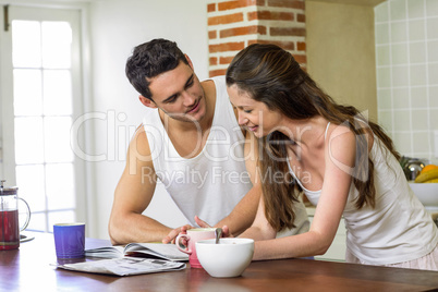 young couple looking their personal organizer in morning