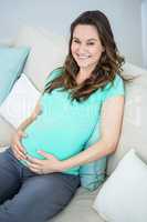 Pregnant woman sitting on couch