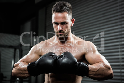 Angry shirtless man with boxe gloves