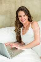 Beautiful brunette woman using laptop