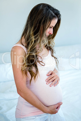 pregnant woman holding her bump
