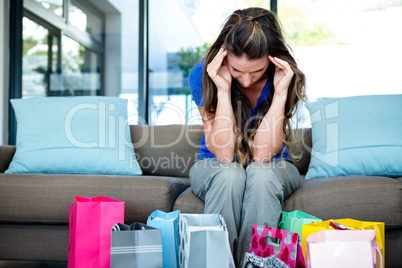 woman with her head in her hands surrounded by gifts