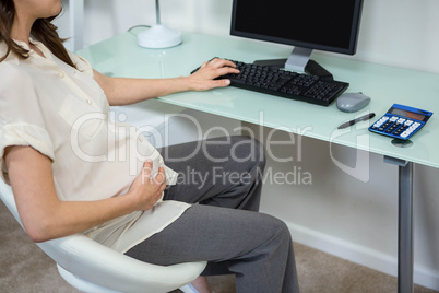 Pregnant woman using computer