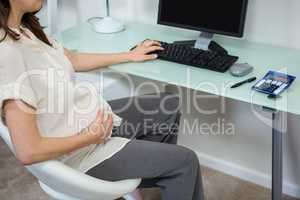 Pregnant woman using computer