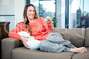 woman lying on the couch with popcorn