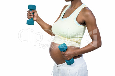 Pregnant woman lifting dumbbell