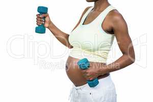 Pregnant woman lifting dumbbell