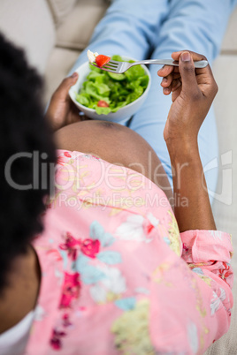 Pregnant woman eating salad