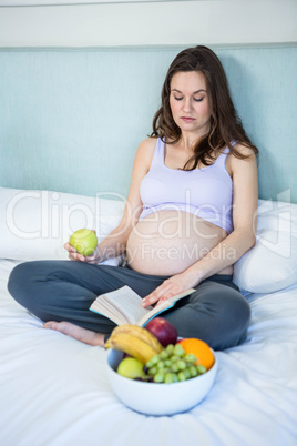 Pregnant woman reading a book