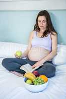 Pregnant woman reading a book
