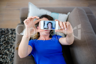 woman taking a selfie on her phone