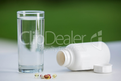 Pills beside glass of water