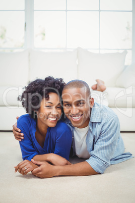 Happy couple lying on the floor