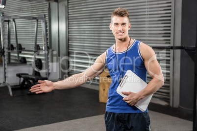 Confident trainer showing the gym to the camera