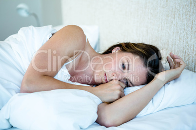 tired woman lying awake in her bed