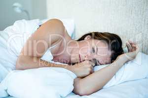 tired woman lying awake in her bed
