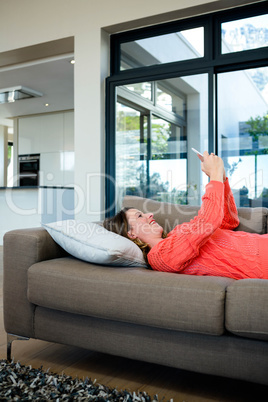 smiling woman taking a selfie on her mobile phone