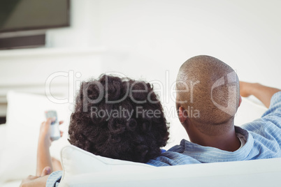 Rear view of couple watching television