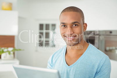 Smiling man using tablet